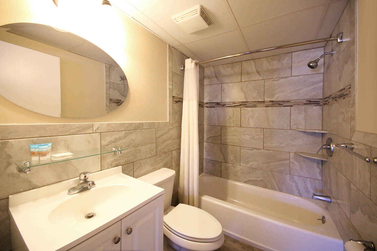 bathroom with tile shower and bath tub